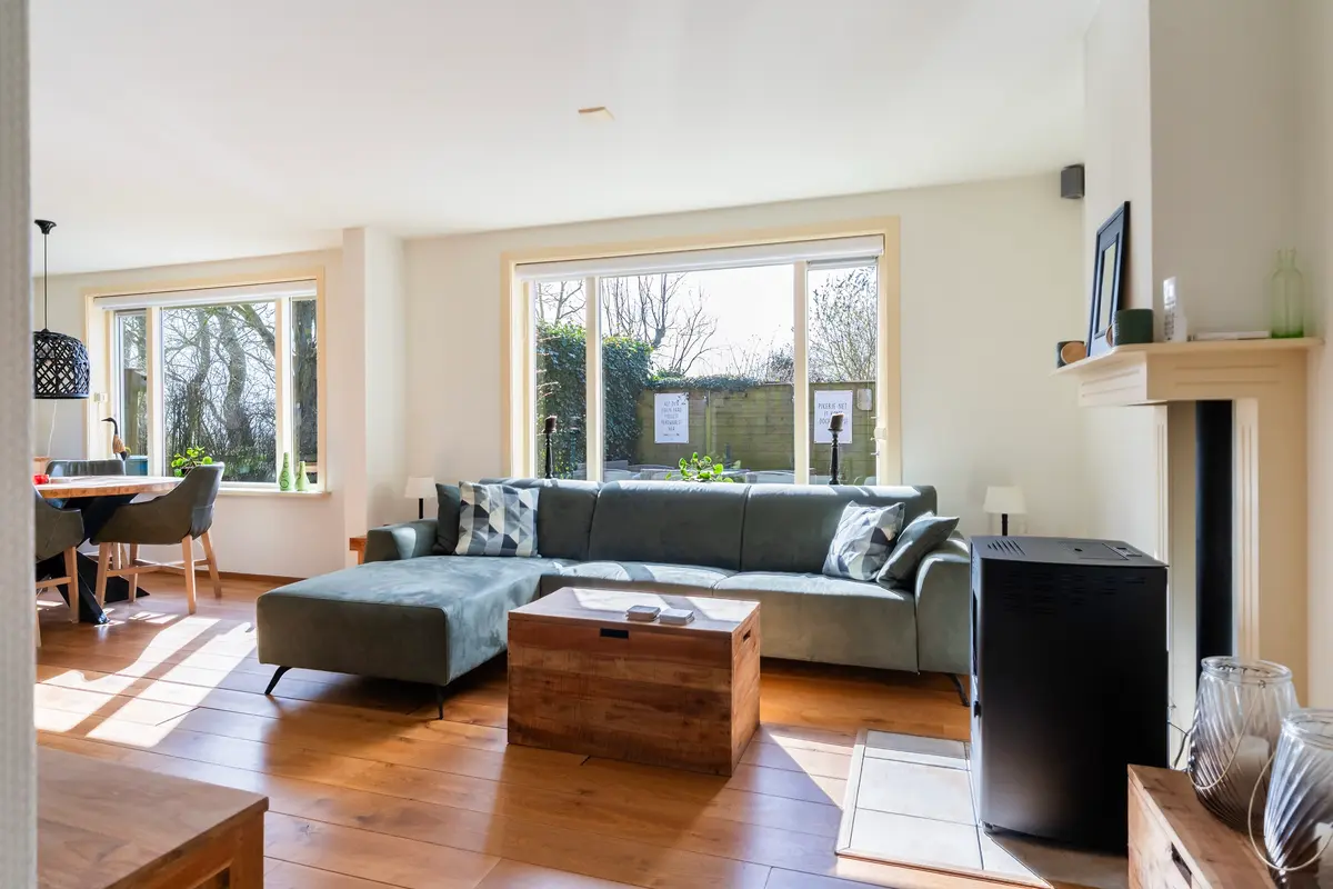 Lichte woonkamer met zithoek en grote ramen